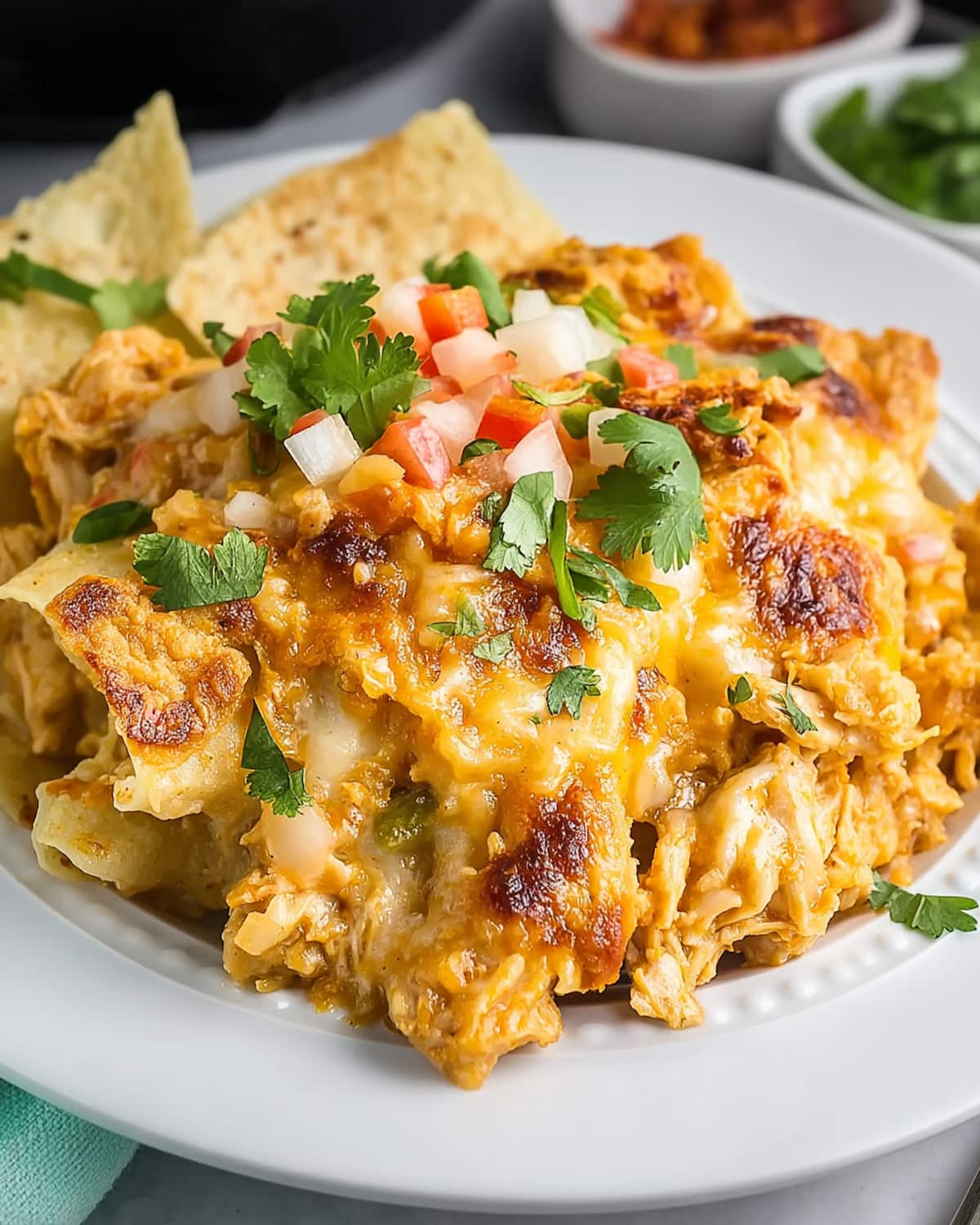 Crock Pot King Ranch Chicken layered with tender chicken, tortillas, rich sauce, and melted cheese, topped with fresh cilantro.
